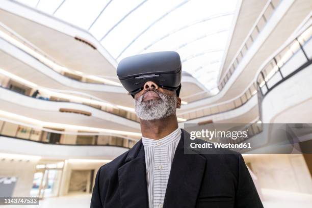 bearded businessman using virtual reality glasses - augmented intelligence stock pictures, royalty-free photos & images