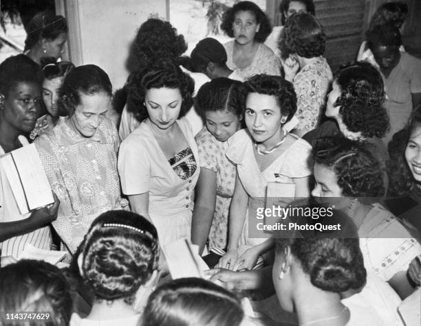 Elevated view of a group of unidentified women as they register to vote on the new territorial constitution, San Juan, Puerto Rico, November 1950.