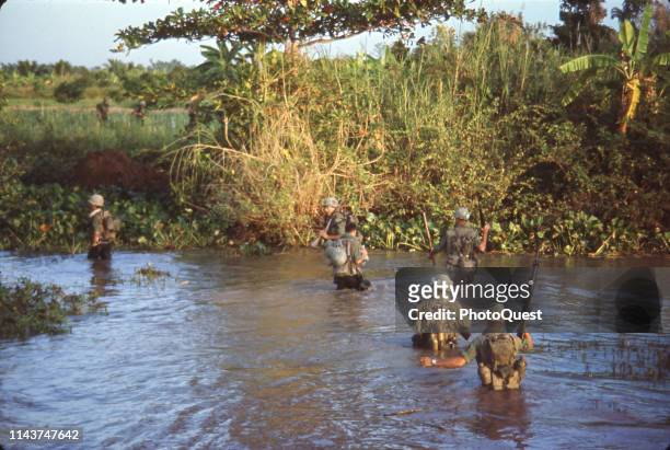 View of US Army troops, from the joint Army/Navy Mobile Riverine Force, wade ashore from the My Tho River during Operation Coronado Nine, Mekong...