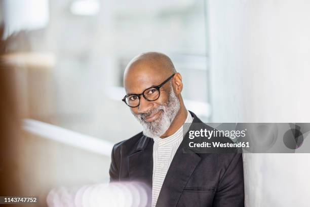 portrait of bald mature businessman with grey beard wearing glasses - bald man foto e immagini stock