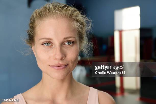 portrait of confident young blond woman in a gym - female blonde blue eyes bildbanksfoton och bilder
