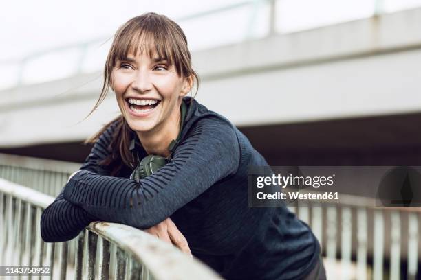 sportive woman with headphones, doing her fitness training outdoors - sports training ストックフォトと画像