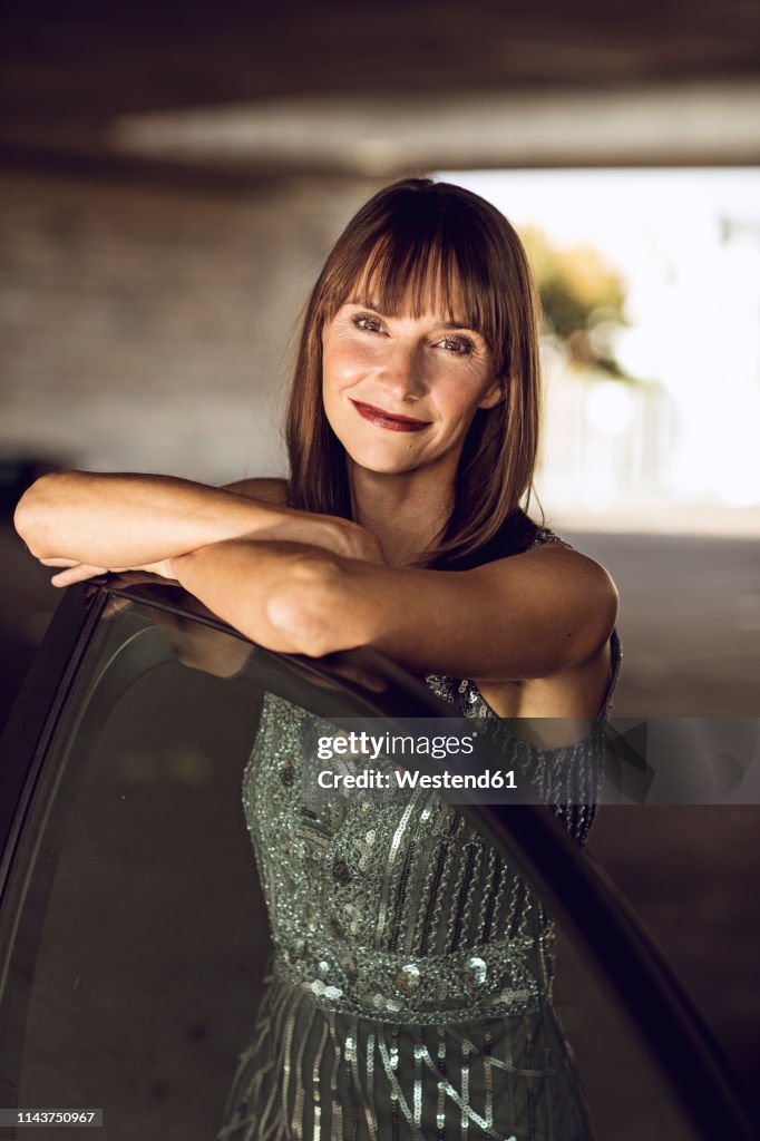 Beautiful woman leaning on car