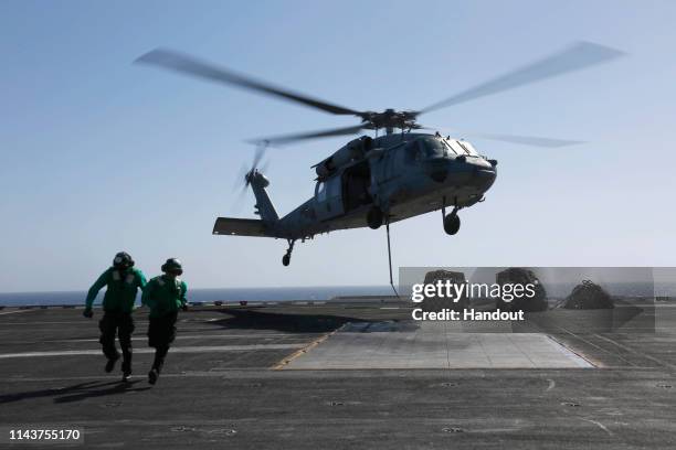 In this handout photo provided by the U.S. Navy, Logistics Specialist 1st Class Ousseinou Kaba , from Silver Spring, Md., and Logistics Specialist...
