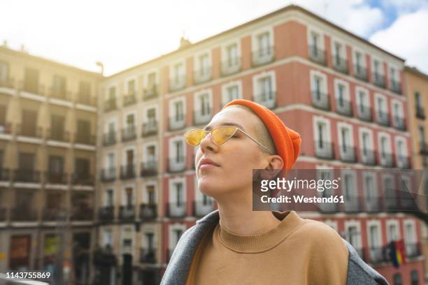 portrait of a young woman with closed eyes in the city - rebellion stock pictures, royalty-free photos & images