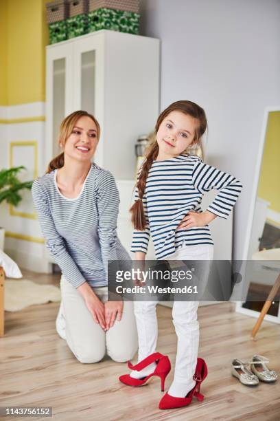 mother and daughter dressing up, wearing matching clothes - mom flirting stockfoto's en -beelden