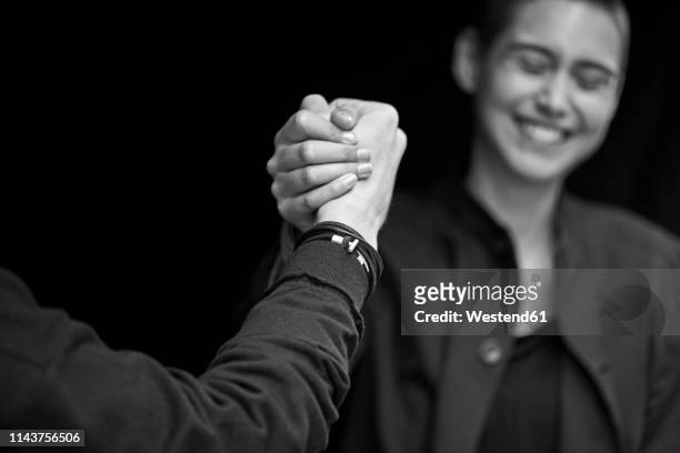 young couple shaking hands - consensus 2018 foto e immagini stock