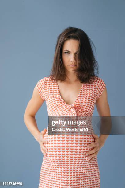 woman pretending to be pregnant, looking angry - thick white women stock pictures, royalty-free photos & images