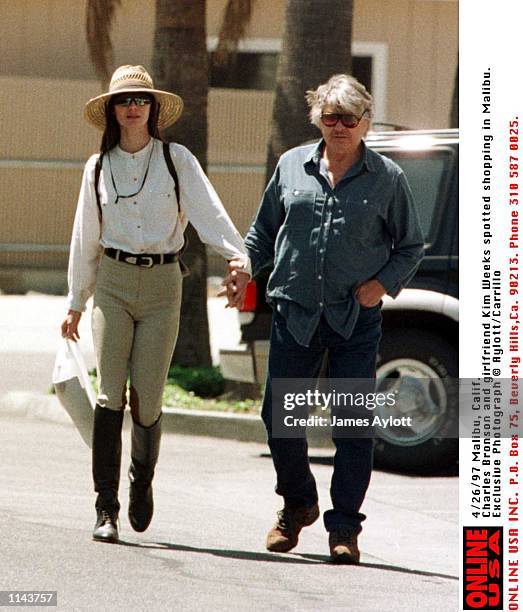 Malibu, Calif Exclusive Photographs. Charles Bronson and his girlfriend Kim Weeks do a spot of shopping in Malibu.