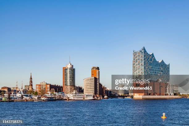 germany, hamburg, cityscape with elbe philharmonic hall seen from the water - hambourg stock pictures, royalty-free photos & images