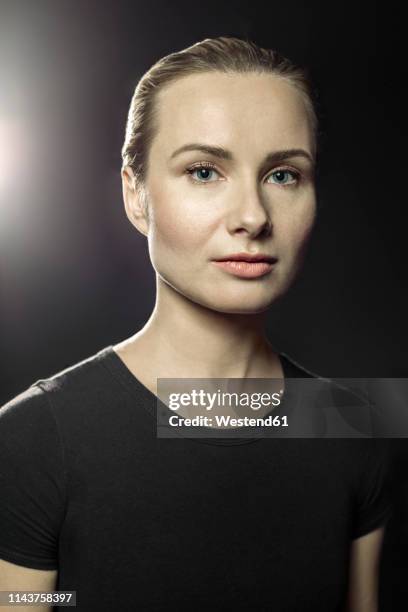 portrait of blond woman in front of black background - blonde hair black background stock pictures, royalty-free photos & images