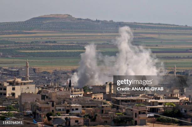 Smoke billows following regime bombardment on the town of Khan Shaykhun in the southern countryside of the rebel-held Idlib province on May 14, 2019....