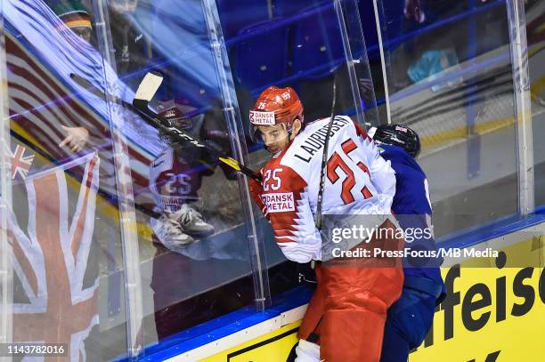 Oliver Lauridsen of Denmark tackles Brett Perlini of Great Britain during the 2019 IIHF Ice Hockey World Championship Slovakia group A game between...