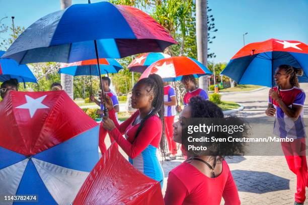 Members of the Cuban animation team wear uniforms and umbrellas with the Cuban flag as receiving clients at the Royalton Hicacos hotel, operated by...