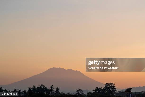 The beutiful colors of first light and sunrise reveal the majestic Mount Agung presiding over Bali and the 2018 Corona Bali Protected at Keramas,...