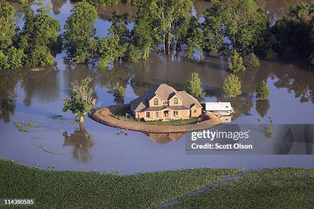 Levee protects a home surrounded by floodwater from the Yazoo River May 18, 2011 near Vicksburg, Mississippi. The flooded Mississippi River is...