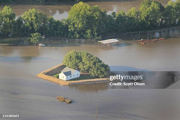 Levee protects a home surrounded by floodwater from the Yazoo River May 18, 2011 near Vicksburg, Mississippi. The flooded Mississippi River is...