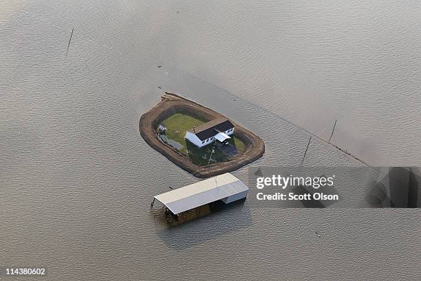 Levee protects a home surrounded by floodwater from the Yazoo River May 18, 2011 near Vicksburg, Mississippi. The flooded Mississippi River is...
