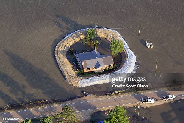 Levee protects a home surrounded by floodwater from the Yazoo River May 18, 2011 near Vicksburg, Mississippi. The flooded Mississippi River is...