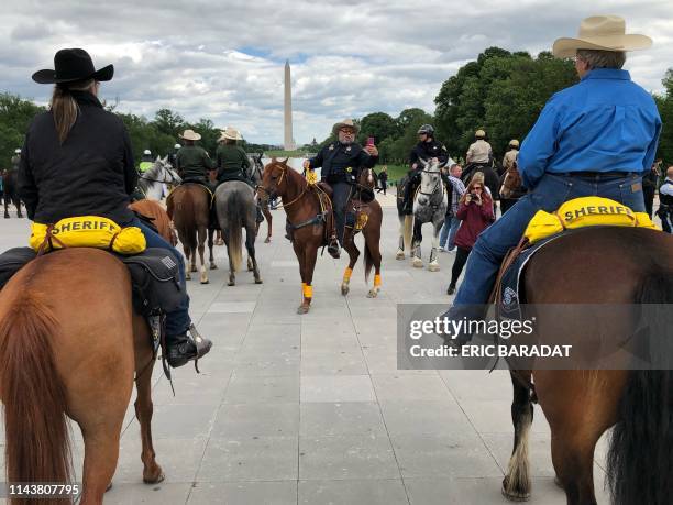 Mounted Police officers are seen in front of the Lincoln Memorial with the Washington monument in the background as they take part in events for...