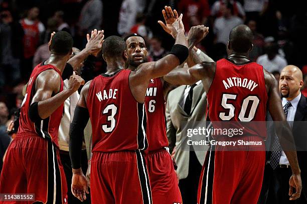 Dwyane Wade, LeBron James and Joel Anthony of the Miami Heat celebrate after they won 85-75 against the Chicago Bulls in Game Two of the Eastern...