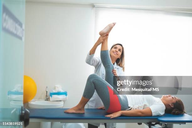 young woman in physical therapy - blonde long legs stock pictures, royalty-free photos & images