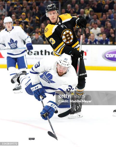 Frederik Gauthier of the Toronto Maple Leafs dives in front of Charlie Coyle of the Boston Bruins for the puck during the first period of Game Five...