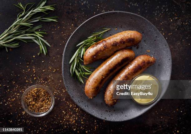 sausages with dijon mustard sauce and seasoning - sausage stock pictures, royalty-free photos & images