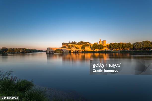 pont saint-benezet on rhone river and avignon cathedral at sunset,avignon - avignon stock-fotos und bilder