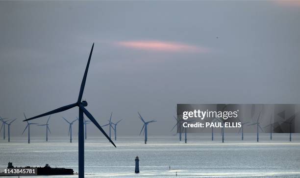 New Brighton lighthouse is pictured at sunset, in New Brighton, at the mouth of the river Mersey, in north-west England on May 14 with the Burbo Bank...