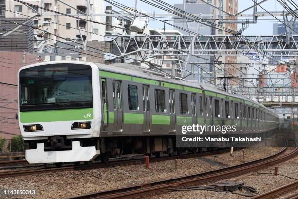 An E231 'Yamanote Line' train runs between Gotanda and Meguro stations on May 27, 2013 in Tokyo, Japan.