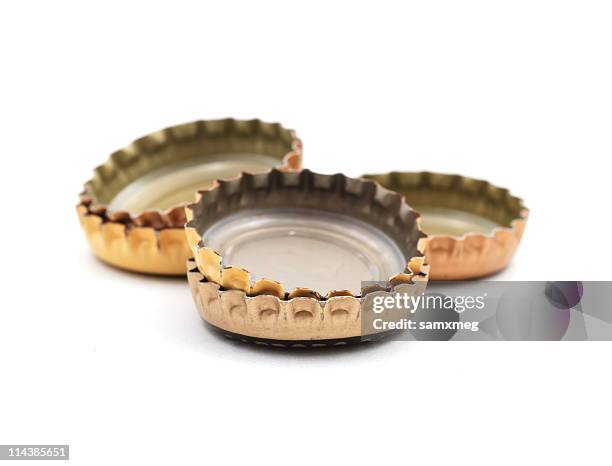 beer bottle caps upside down on a white background - beer cap stock pictures, royalty-free photos & images