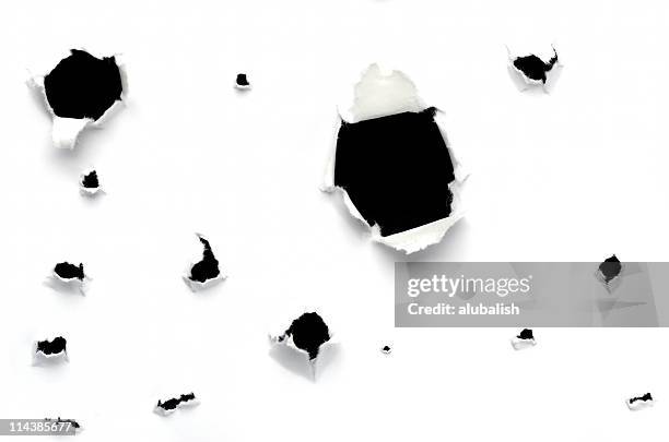 holes in paper - bullet hole stock pictures, royalty-free photos & images