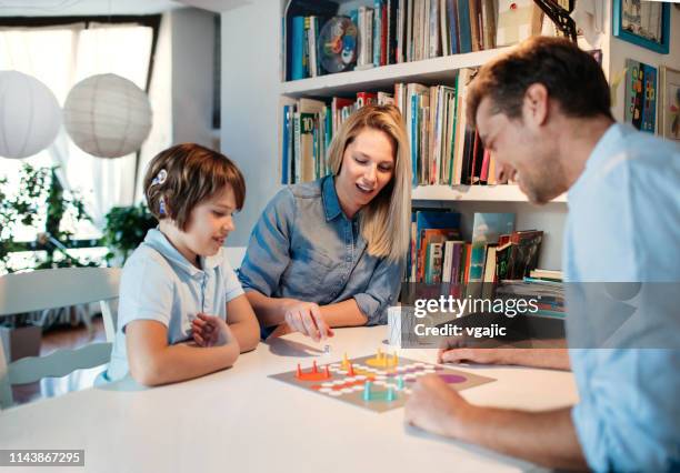 family playing board game - playing board games stock pictures, royalty-free photos & images