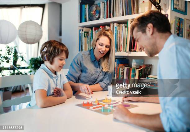 family playing board game - board games imagens e fotografias de stock