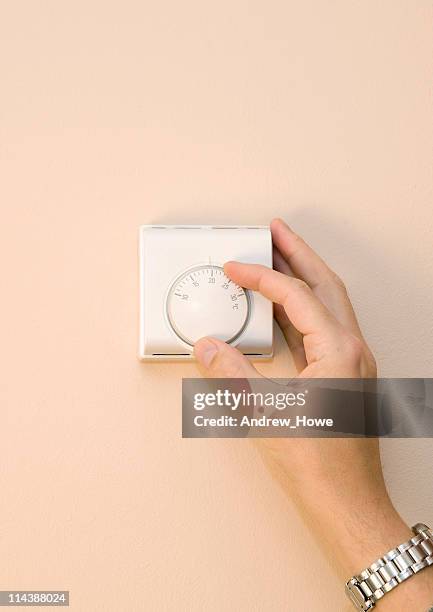 home thermostat - turn dial stock pictures, royalty-free photos & images