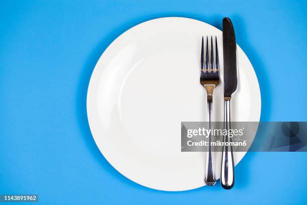 directly above shot of plate with fork and table knife - bestick bildbanksfoton och bilder