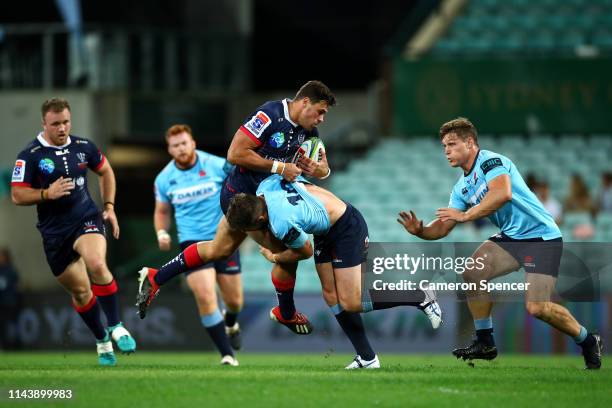 Tom English of the Rebels is tackled during the round 10 Super Rugby match between the Waratahs and the Melbourne Rebels at the Sydney Cricket Ground...