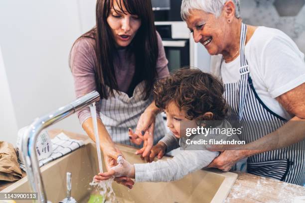 washing hands - child washing hands stock pictures, royalty-free photos & images