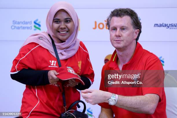 Steve McManaman former Liverpool player and legend poses with a fan after signing an autograph during the meet and greet fans session at the One...