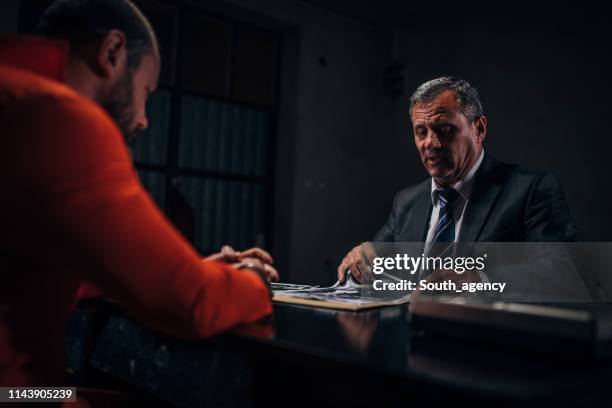 detective and prisoner in interrogation room - probation stock pictures, royalty-free photos & images