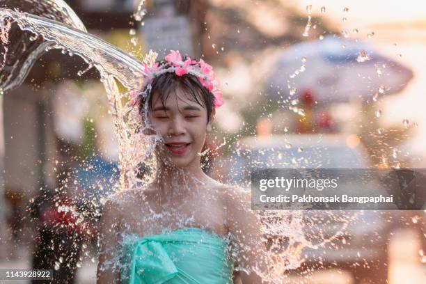 children with songkran festival, children are splashed at the face in songkran festival, water and people face - songkran festival stock-fotos und bilder