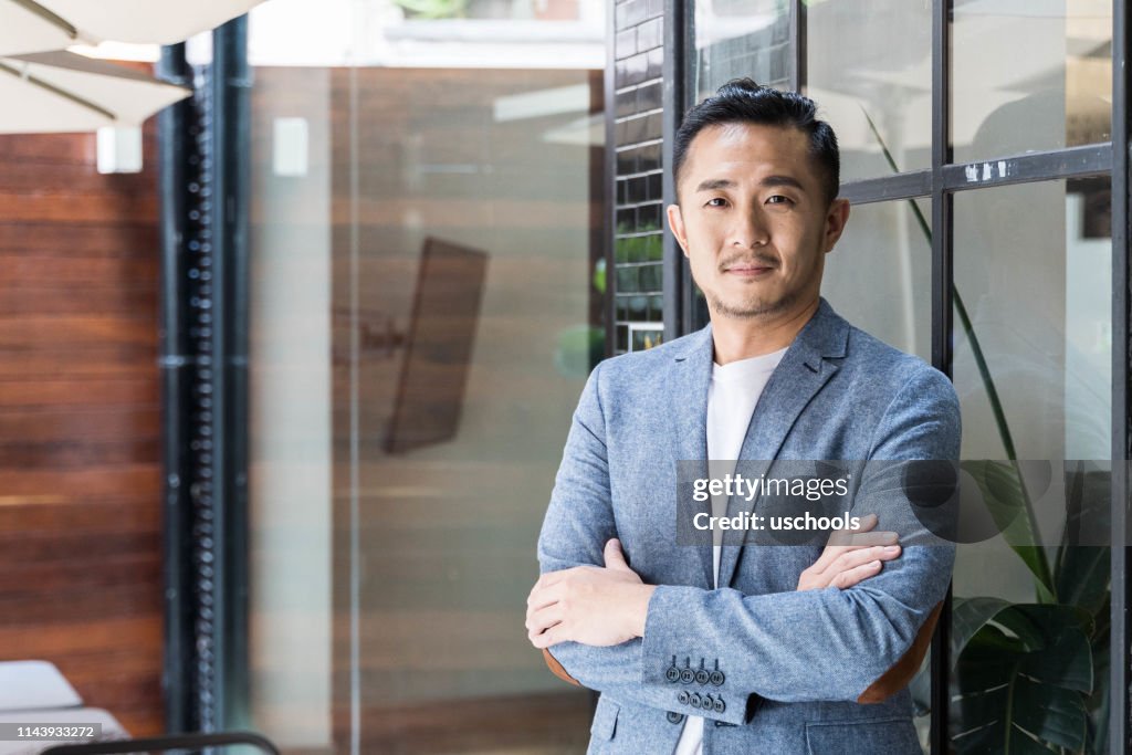 Successful Asian Businessman in a Modern Coworking Space