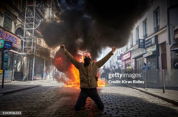 Gilet Jaune in front of a burning barricade during Act 23 of Gilets Jaunes or 'Yellow Vest' protests, just five days after the fire of Notre-Dame...