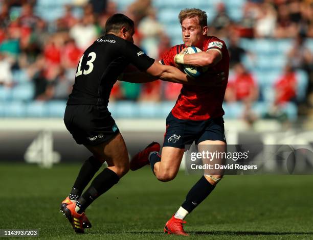 Mike Haley of Munster Rugby is tackled by Alex Lozowski of Saracens during the Champions Cup Semi Final match between Saracens and Munster at Ricoh...