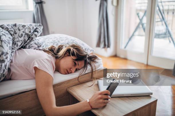 sleepy young woman - bedside table stock pictures, royalty-free photos & images