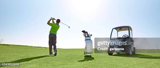 golf player - golf swing from behind stock pictures, royalty-free photos & images