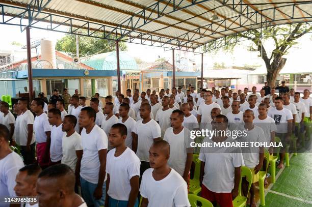 Prisoners granted royal pardon attend a ceremony at the Narathiwat provincial jail in Thailand's southern province of Narathiwat on May 15, 2019. - A...