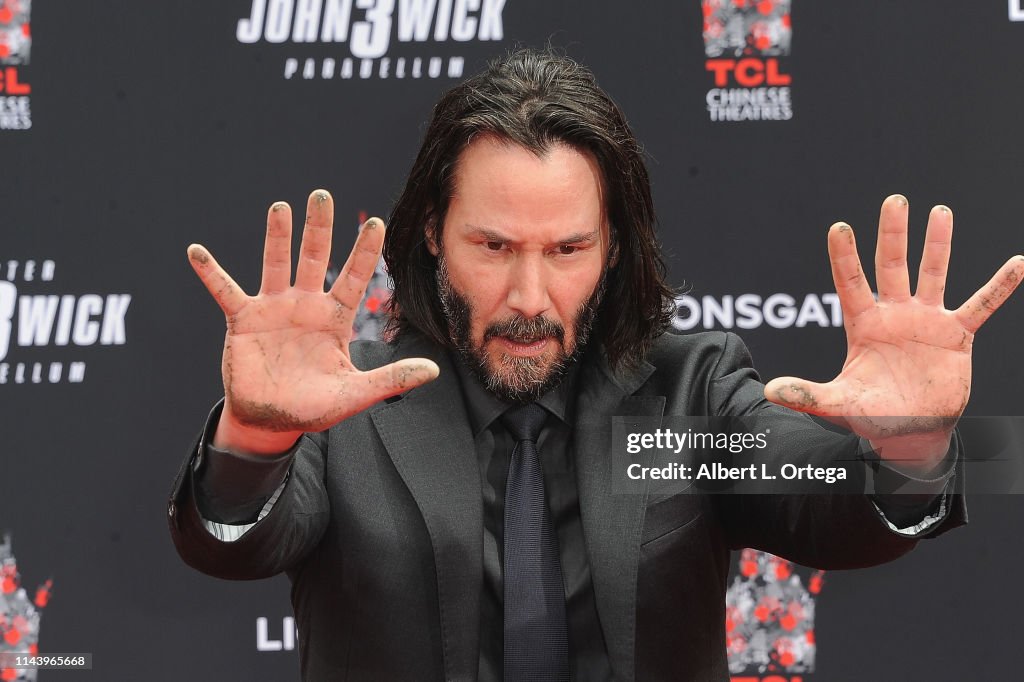 Keanu Reeves Places His Hand Prints In Cement At TCL Chinese Theatre IMAX Forecourt