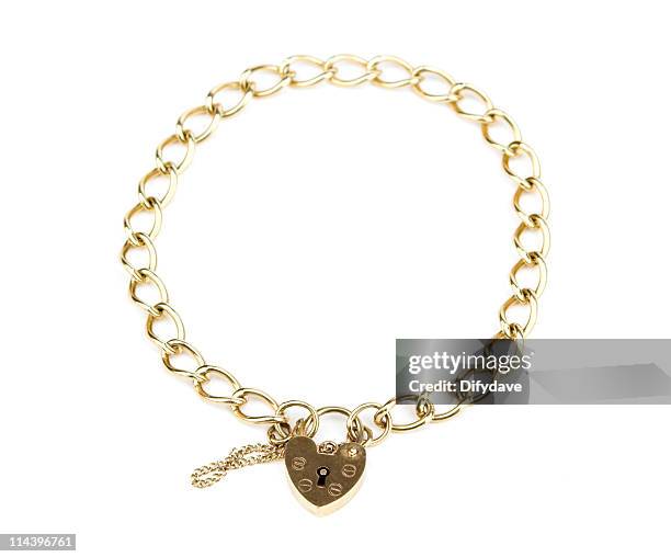 gold chain bracelet with heart shaped padlock clasp - bacelet stock pictures, royalty-free photos & images